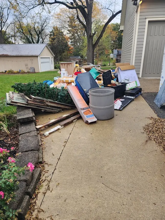 Dumpster being loaded with debris for 12 Yard Dumpster Rental in Vernal